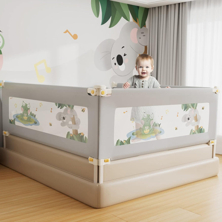 A toddler bed with a gray press guardrail featuring a frog design. The bed is set against a wall with a colorful frog-themed mural.