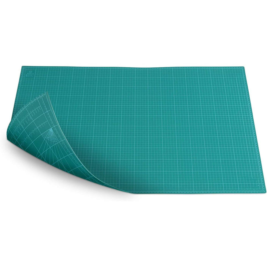 Teal cutting mat with grid pattern on a white background