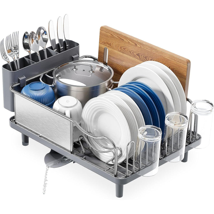 Dish drying rack with cutlery, plates, and glasses on a white background