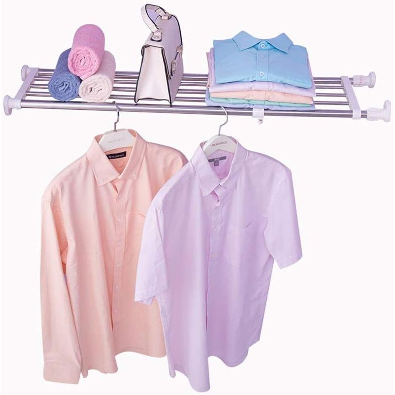 Clothing rack with shirts and hangers on a white background