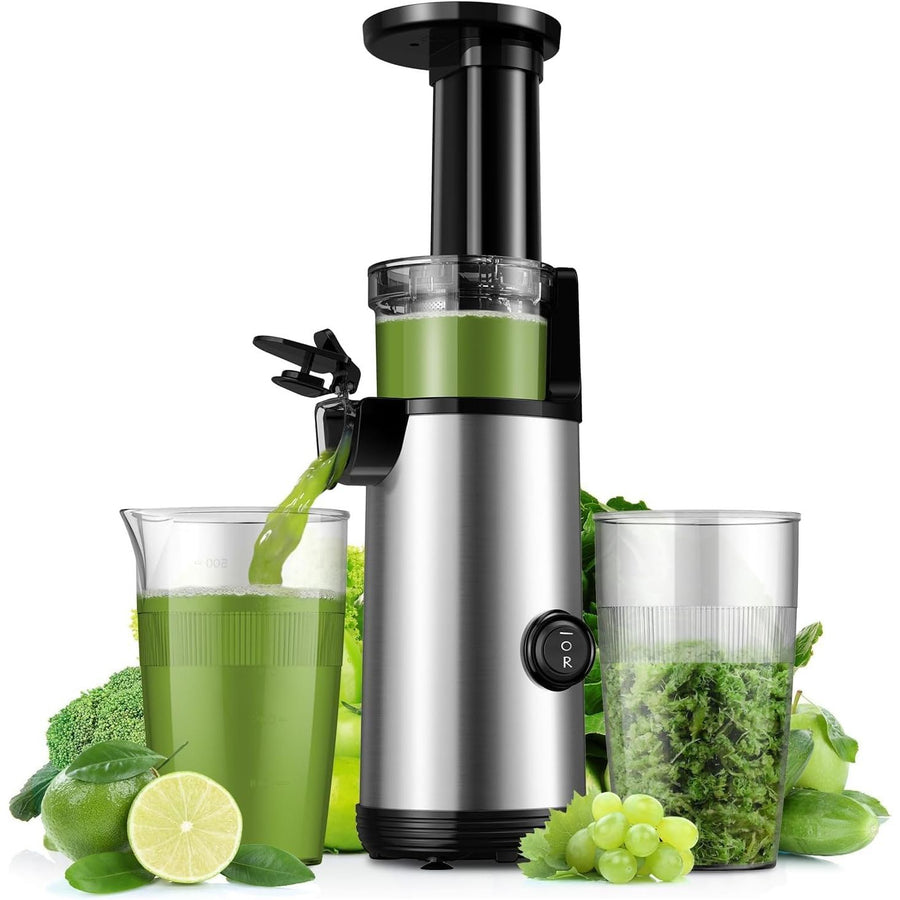 Juicer with green juice and vegetables on a white background