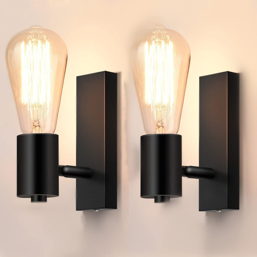 Black wall sconces with vintage-style light bulbs on a neutral background
