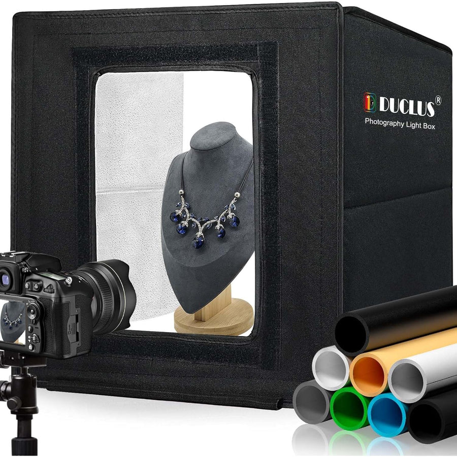 DUCLUS 40cm photo light box displayed with a camera and various colored backdrops, also showing a necklace on a mannequin inside the box.