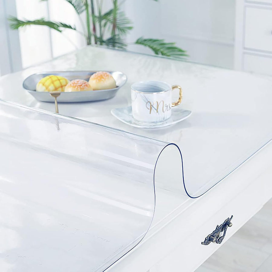 Clear table mat on a white surface with a cup and plate in the background