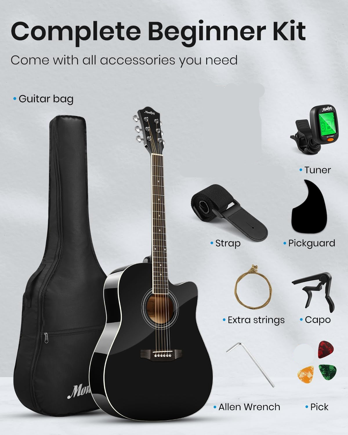 Black acoustic guitar with accessories on a light gray background