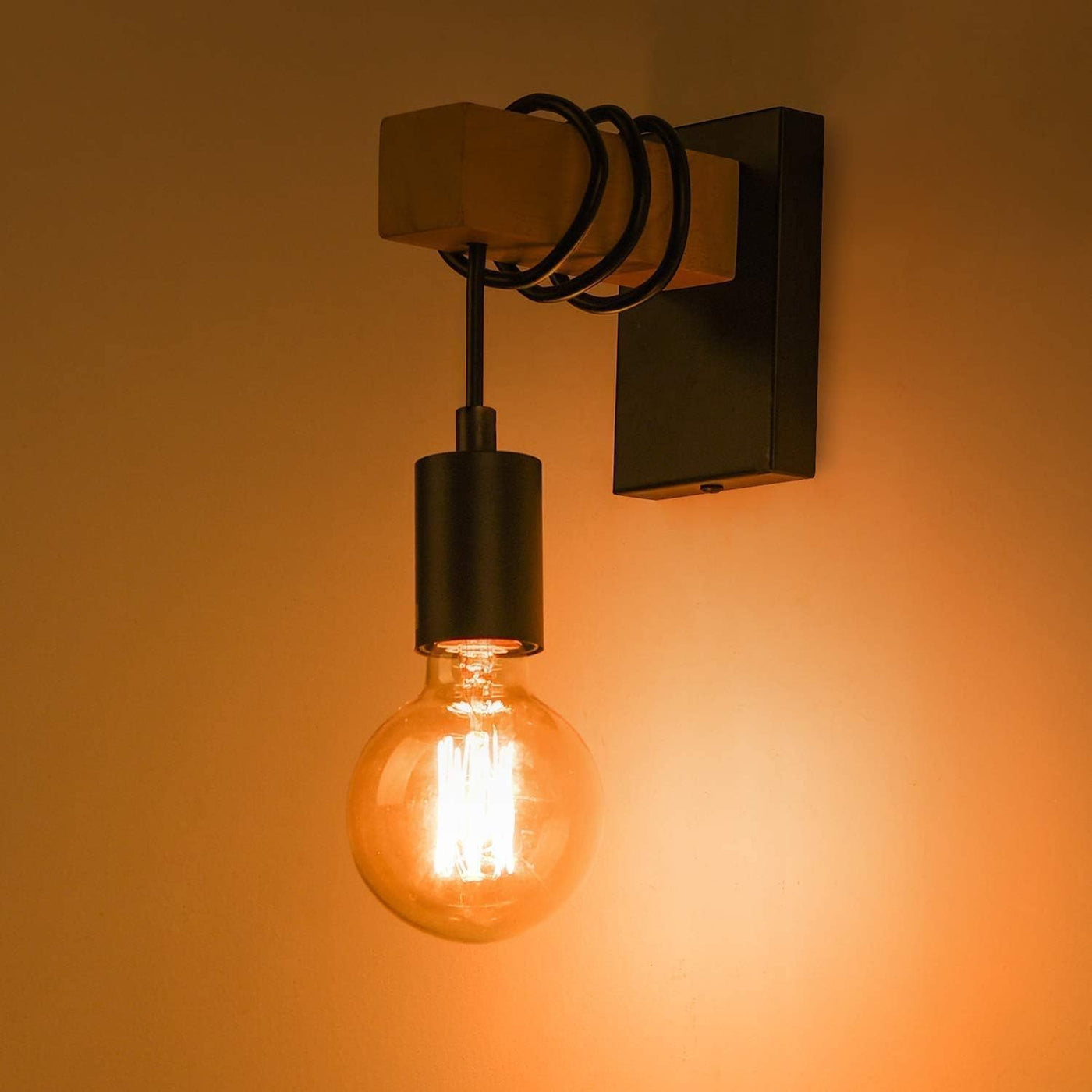 Wall-mounted light fixture with a glowing bulb on an orange background