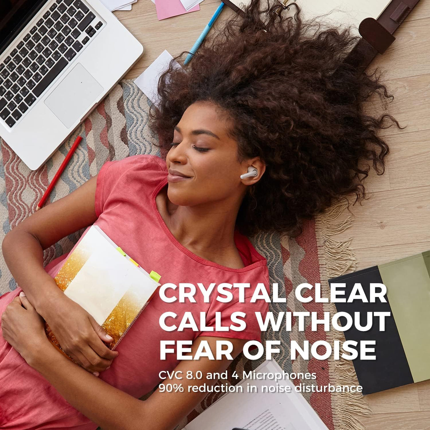 Woman lying on floor with laptop and notebook using earbuds, text about crystal clear calls and noise reduction.