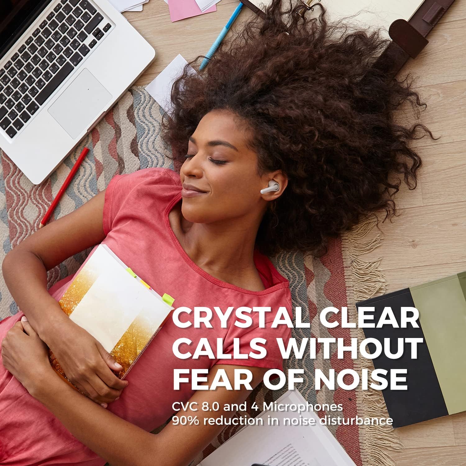 Woman lying on floor with laptop and notebook using earbuds, text about crystal clear calls and noise reduction.