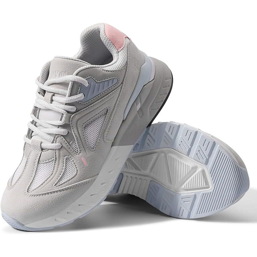 A pair of white leather women's sneakers with lace-up closure and a rubber sole, designed for comfort and support.