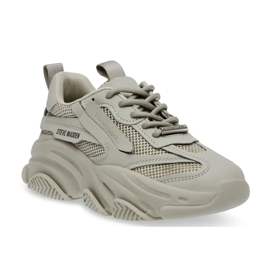 A pair of Steve Madden Possession-E Trainer sneakers in a beige color with a chunky sole and lace-up closure.