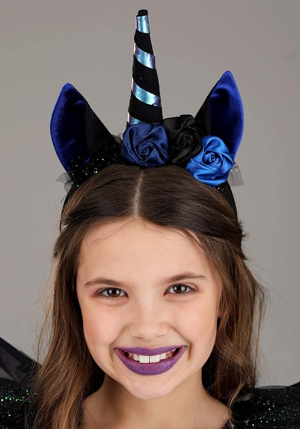 Girl wearing a decorative headband with blue and black roses and a unicorn horn on a gray background