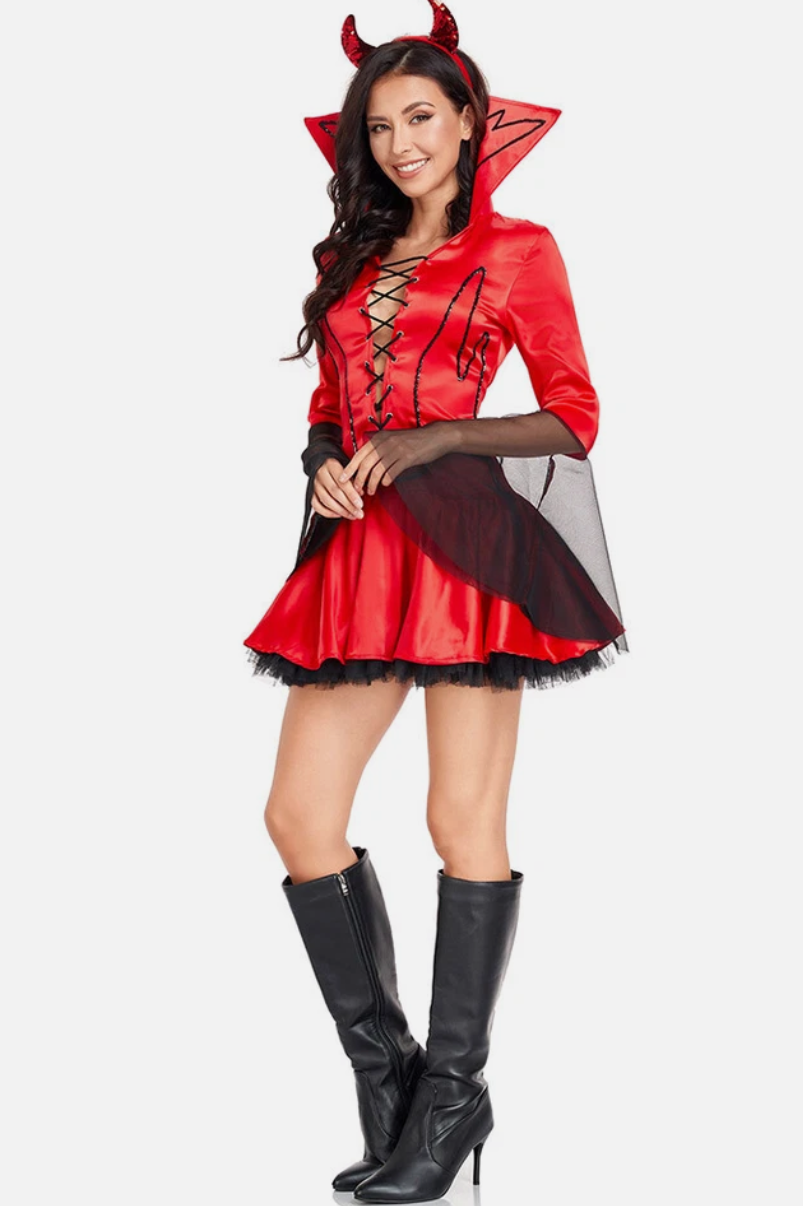 Woman wearing a red devil costume with horns on a white background
