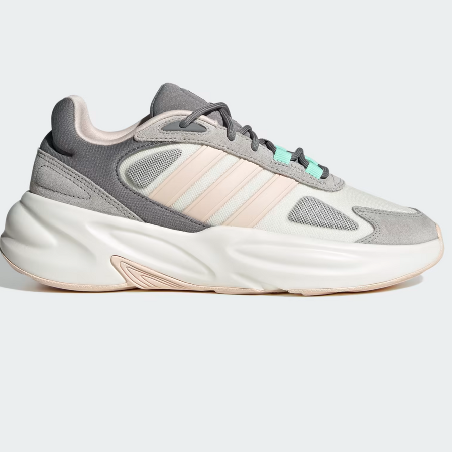 A pair of Adidas Ozelle Cloudfoam Lifestyle Running Shoes in white, gray, and mint green colors with a chunky rubber outsole.