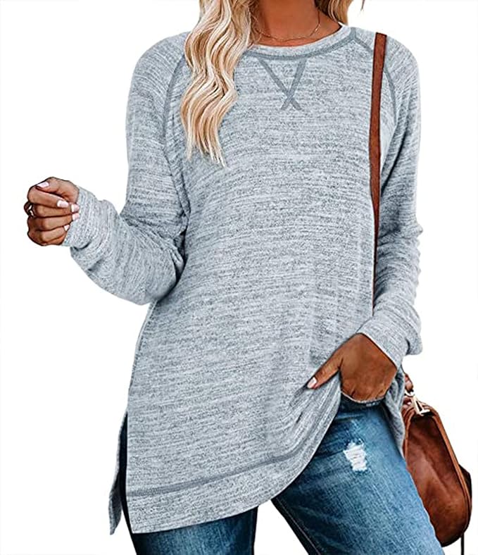 Person wearing a gray long-sleeve top and blue jeans with a brown bag.