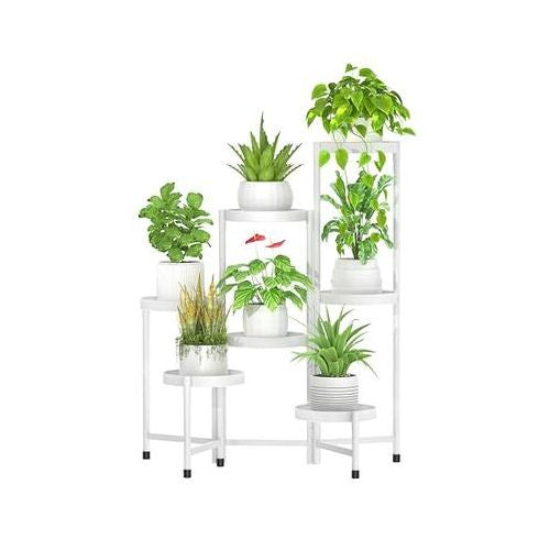 A white 7-tier metal corner plant stand with various plants in different pots, designed for indoor and outdoor use.