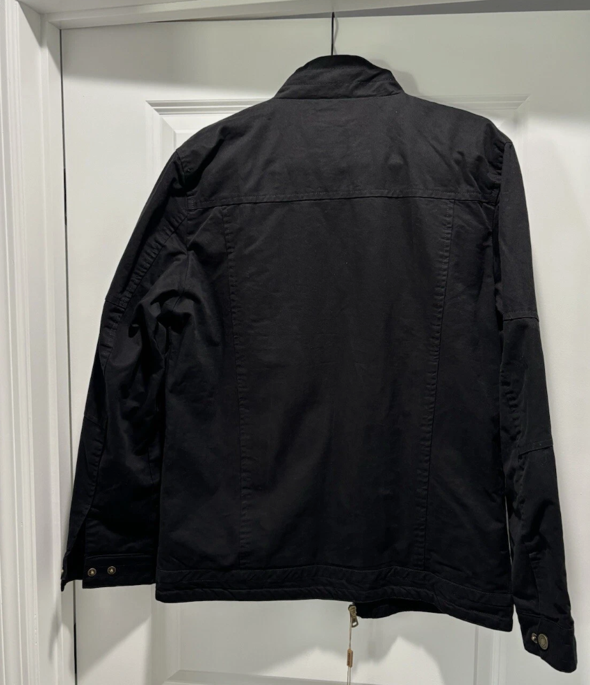 Black jacket hanging on a white door