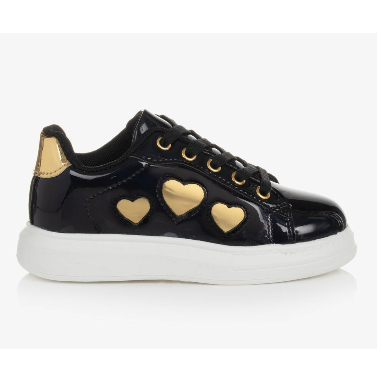 Children's black patent trainers with gold heart details and a white non-slip sole.