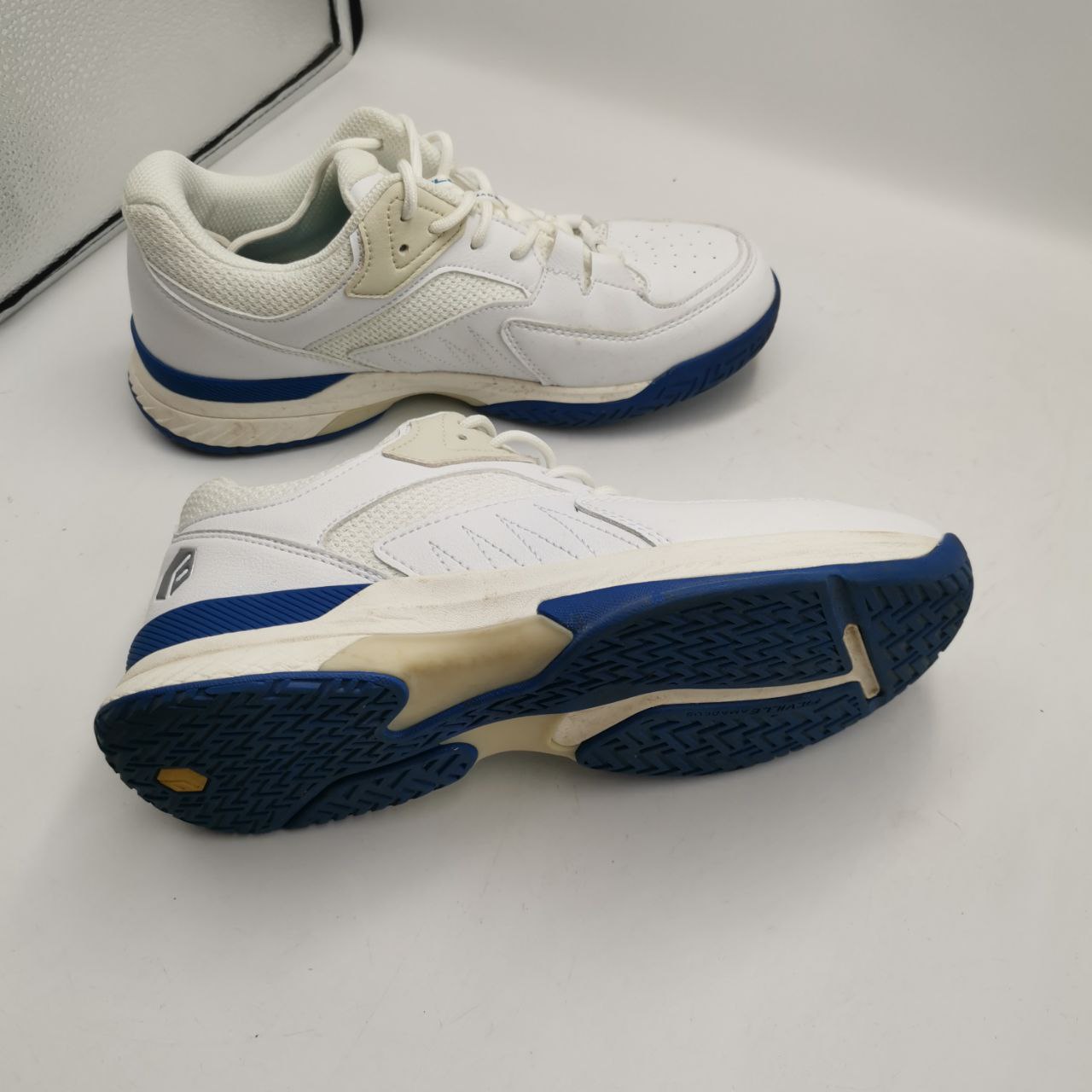 A pair of white FitVille men's extra wide non-slip trainers with blue accents, UK 7 - EU 40, displayed on a white surface.