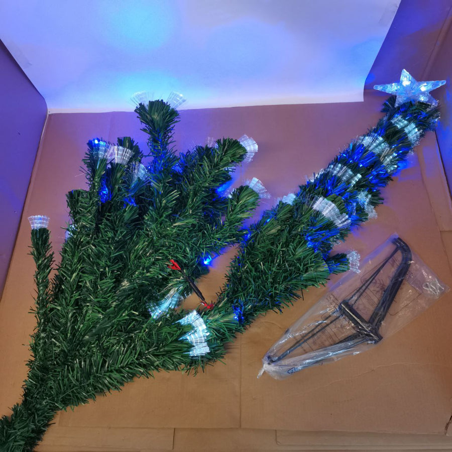 Artificial green Christmas tree with fiber optic lights and a metal stand, displaying branch tips and a large transparent star at the top.