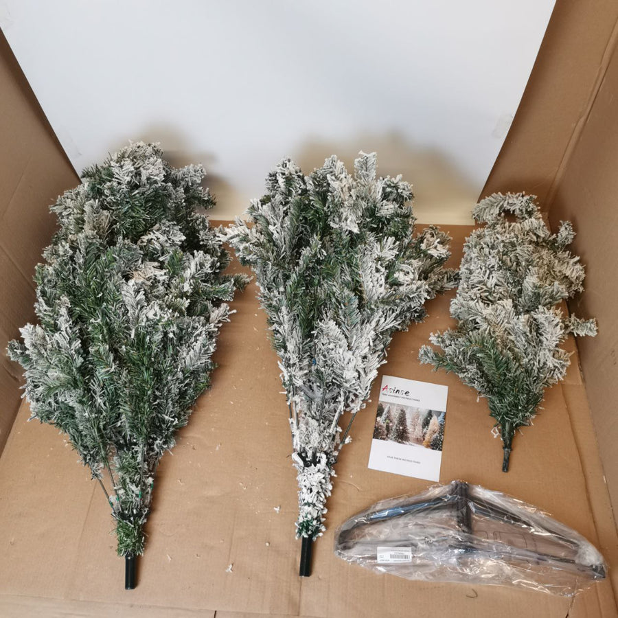 Artificial Christmas trees with heavy white snow flocking and metal stands, displayed in a cardboard box.