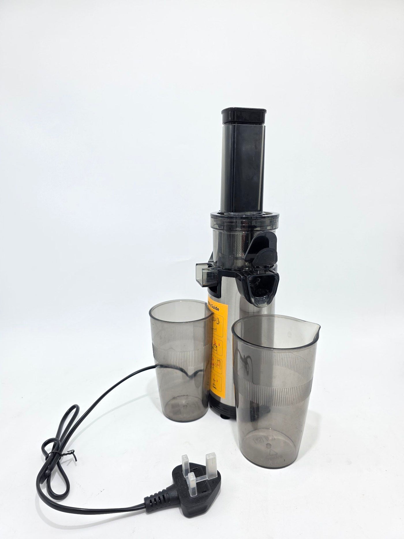 Black handheld juicer with two clear plastic cups and a power cord on a white background