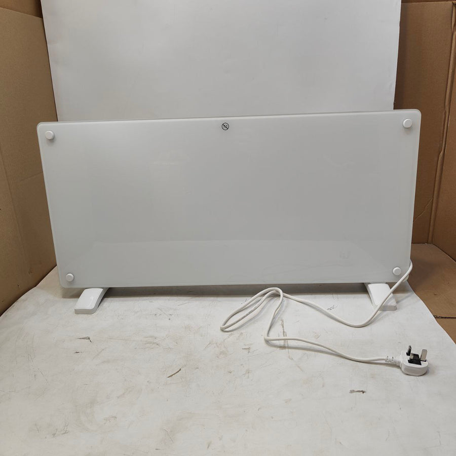 White electric radiator on a white surface with a cardboard box in the background