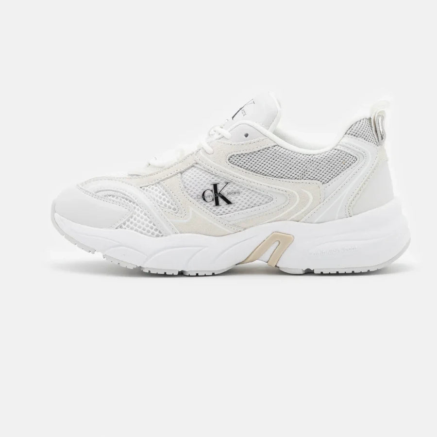 A pair of Calvin Klein Jeans retro tennis trainers, featuring a white suede and mesh material with a low-top design and flat rubber sole.