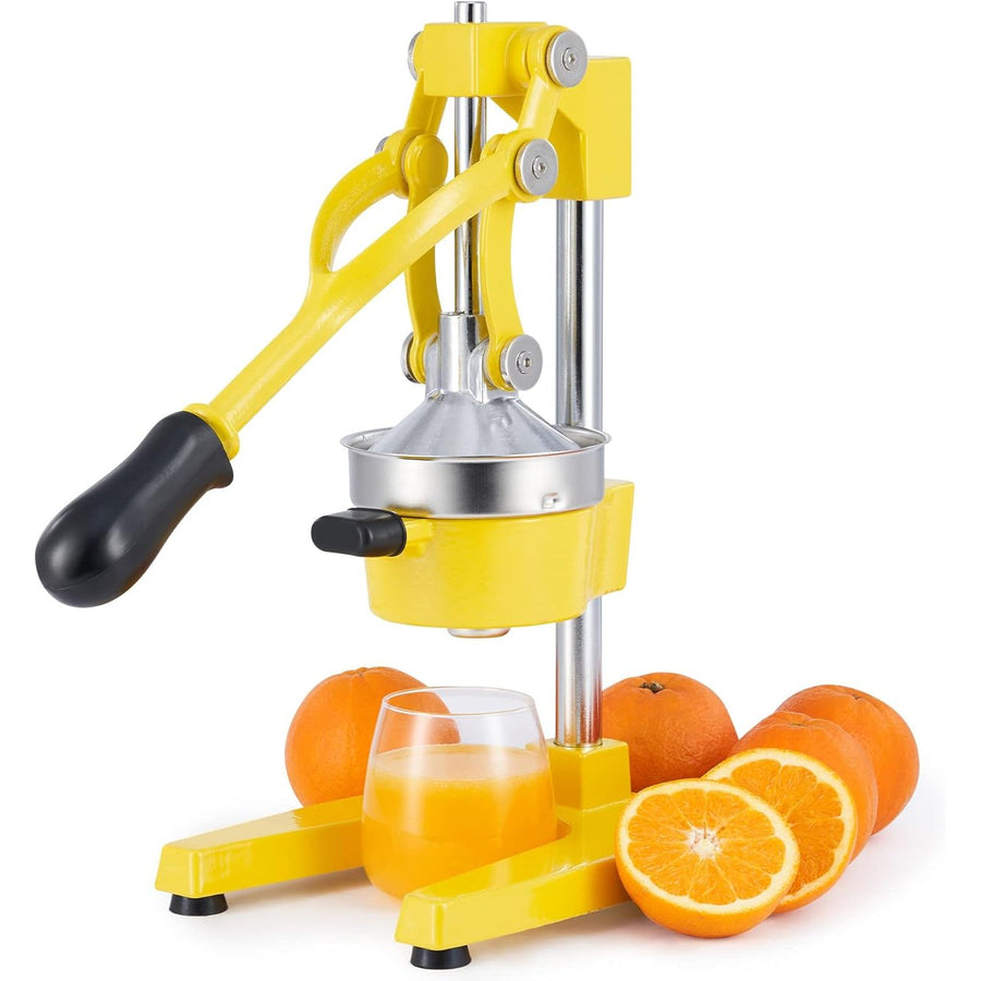Yellow manual orange juicer with oranges and a glass of juice on a white background