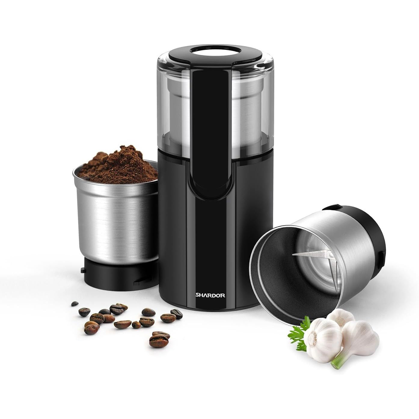 Black and silver coffee grinder with beans and garlic on a white background