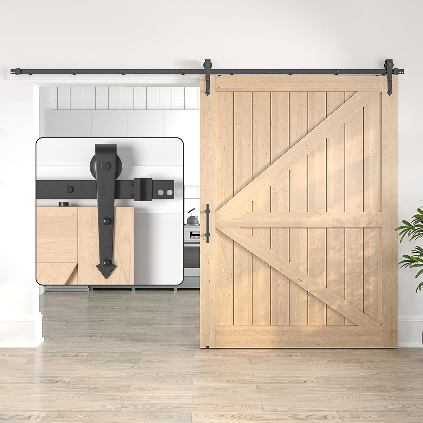 Wooden sliding barn door with black hardware in a modern interior setting.