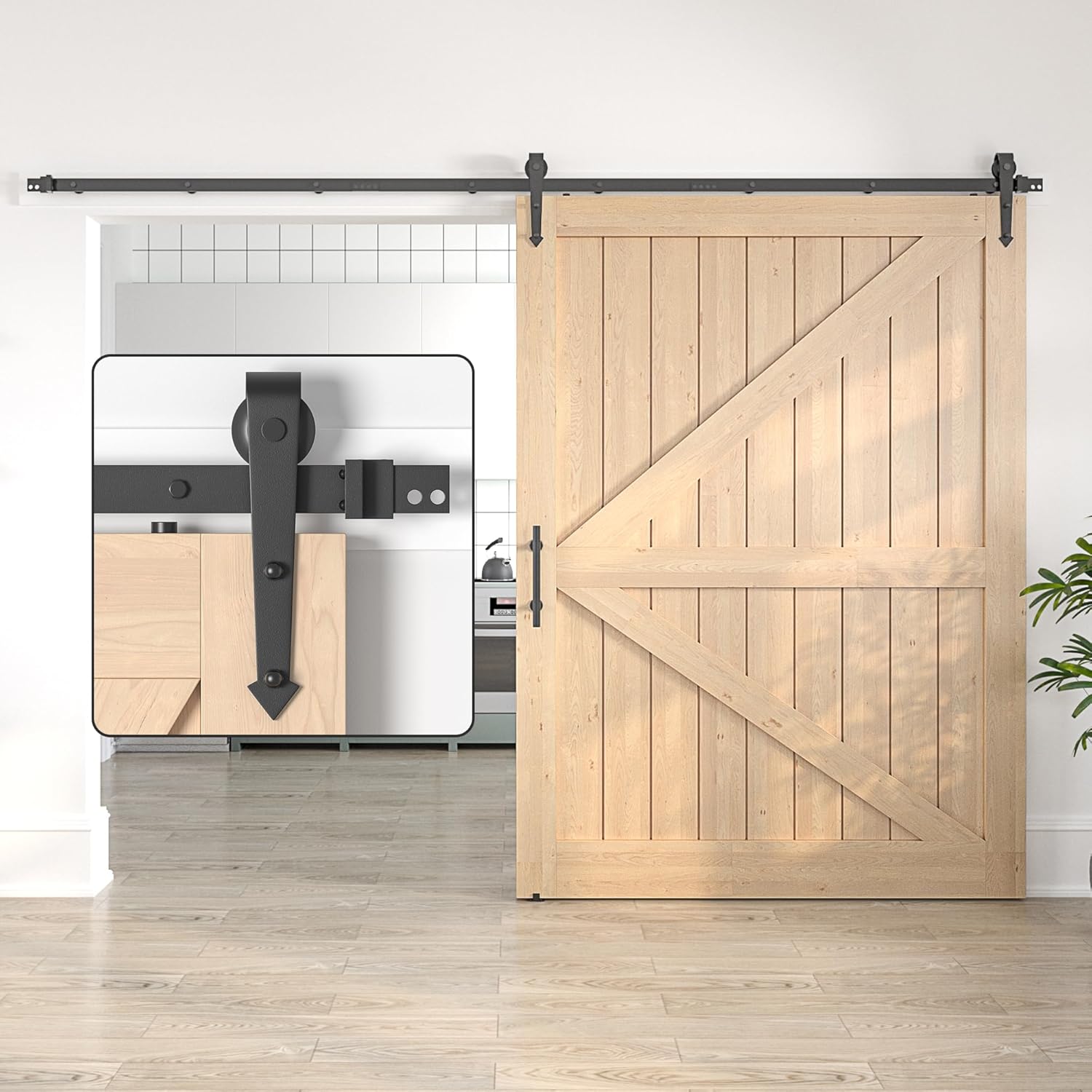 Wooden sliding barn door with black hardware in a modern interior setting.