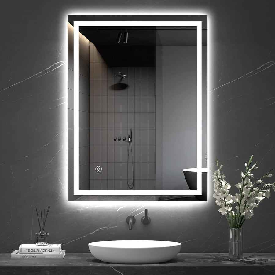 Bathroom with a large illuminated mirror above a sink, featuring modern fixtures and decor.