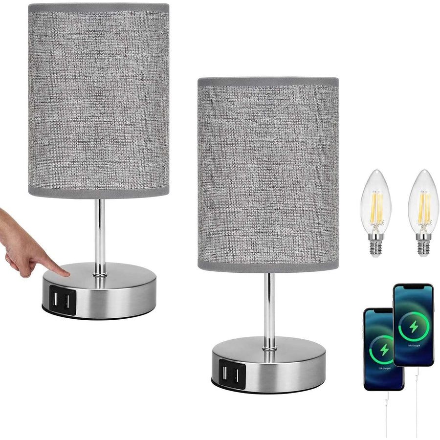 Two gray table lamps with USB ports on a white background, including two light bulbs and a smartphone.