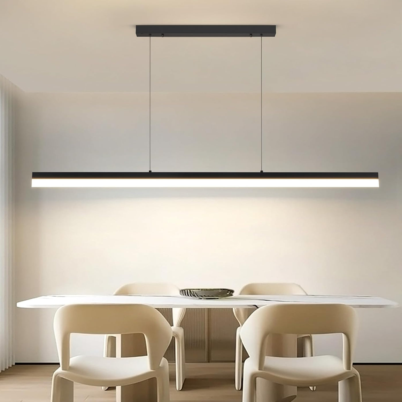 Modern dining room with a long rectangular table and chairs, featuring a linear pendant light.