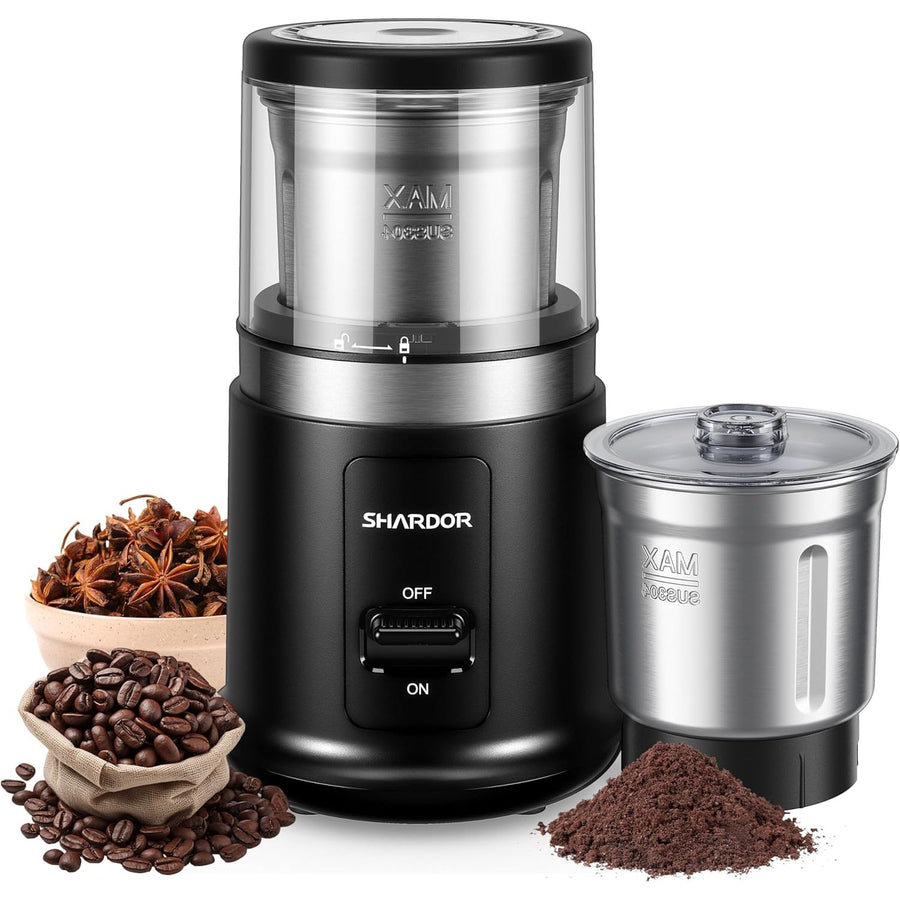 Coffee grinder with coffee beans, spices, and ground coffee on a white background