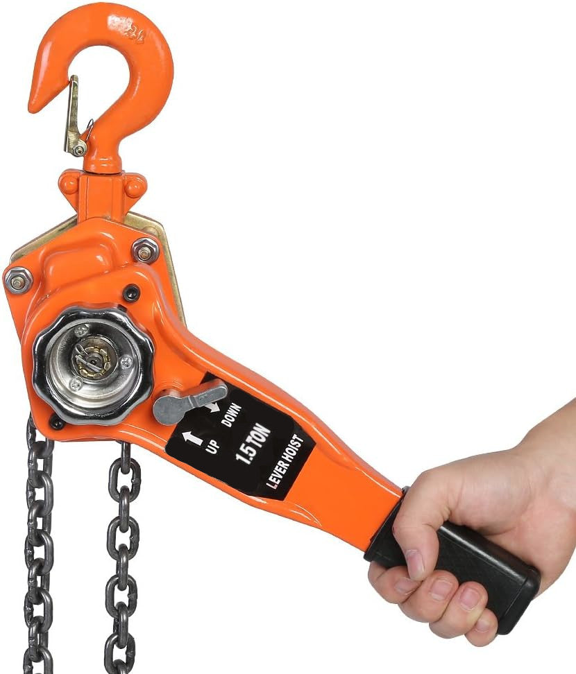 Orange hand chain hoist with a hand holding it on a white background