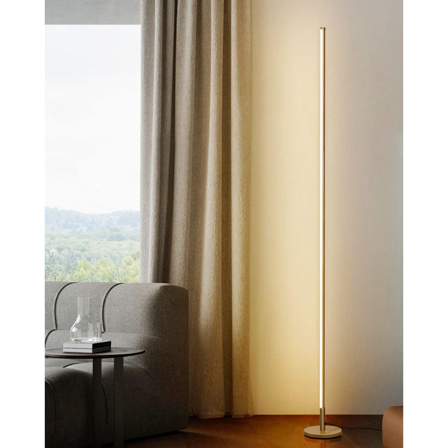 Modern floor lamp in a living room setting with a curtain and chair.