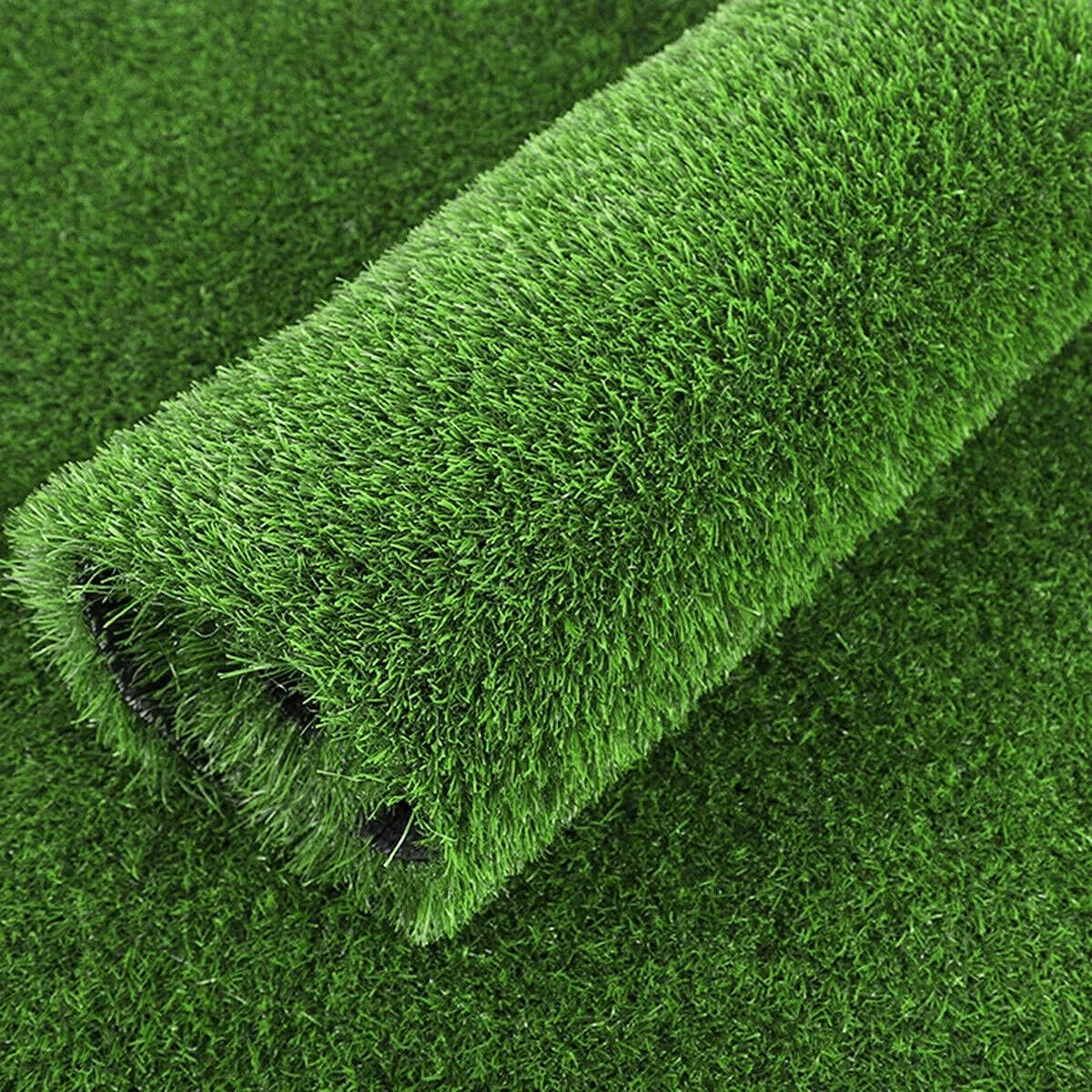 Roll of artificial grass on a green background