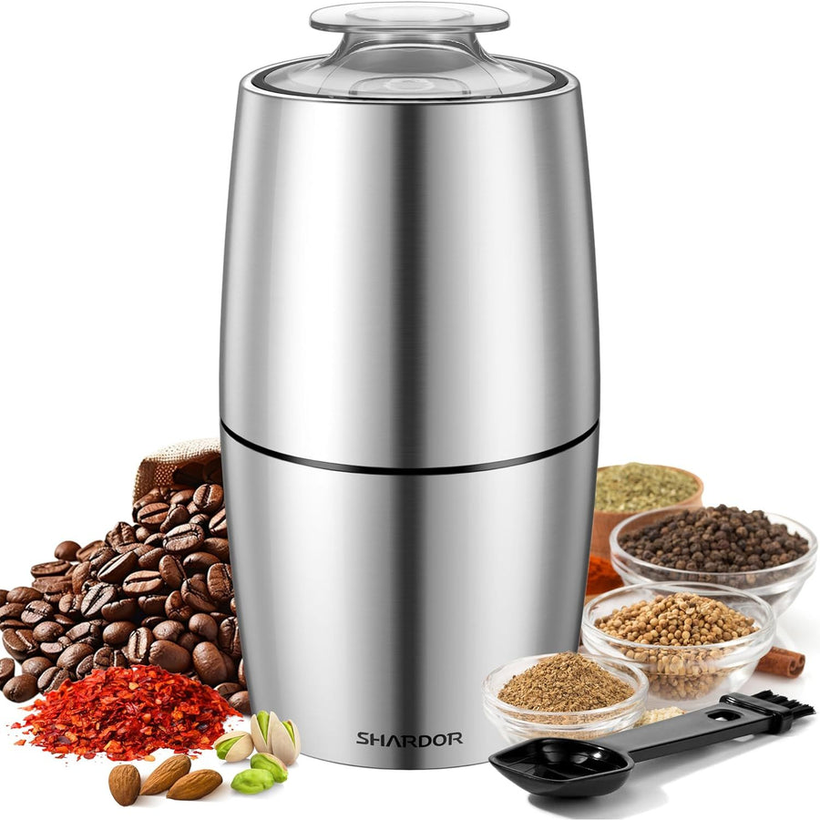 Silver spice grinder with various spices and ingredients on a white background