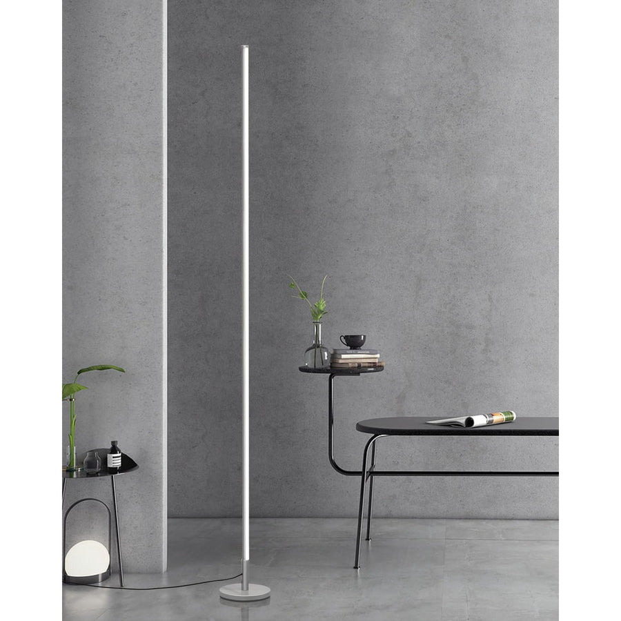 Modern floor lamp against a gray wall with minimal decor