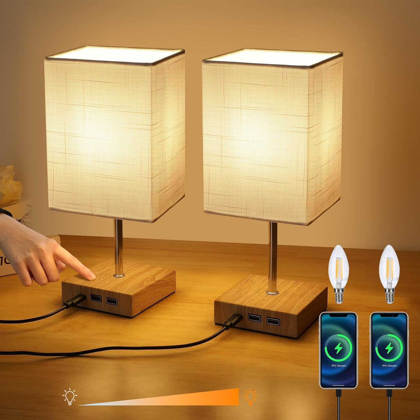 Two table lamps with wooden bases and fabric shades, connected to a power source, on a wooden surface.