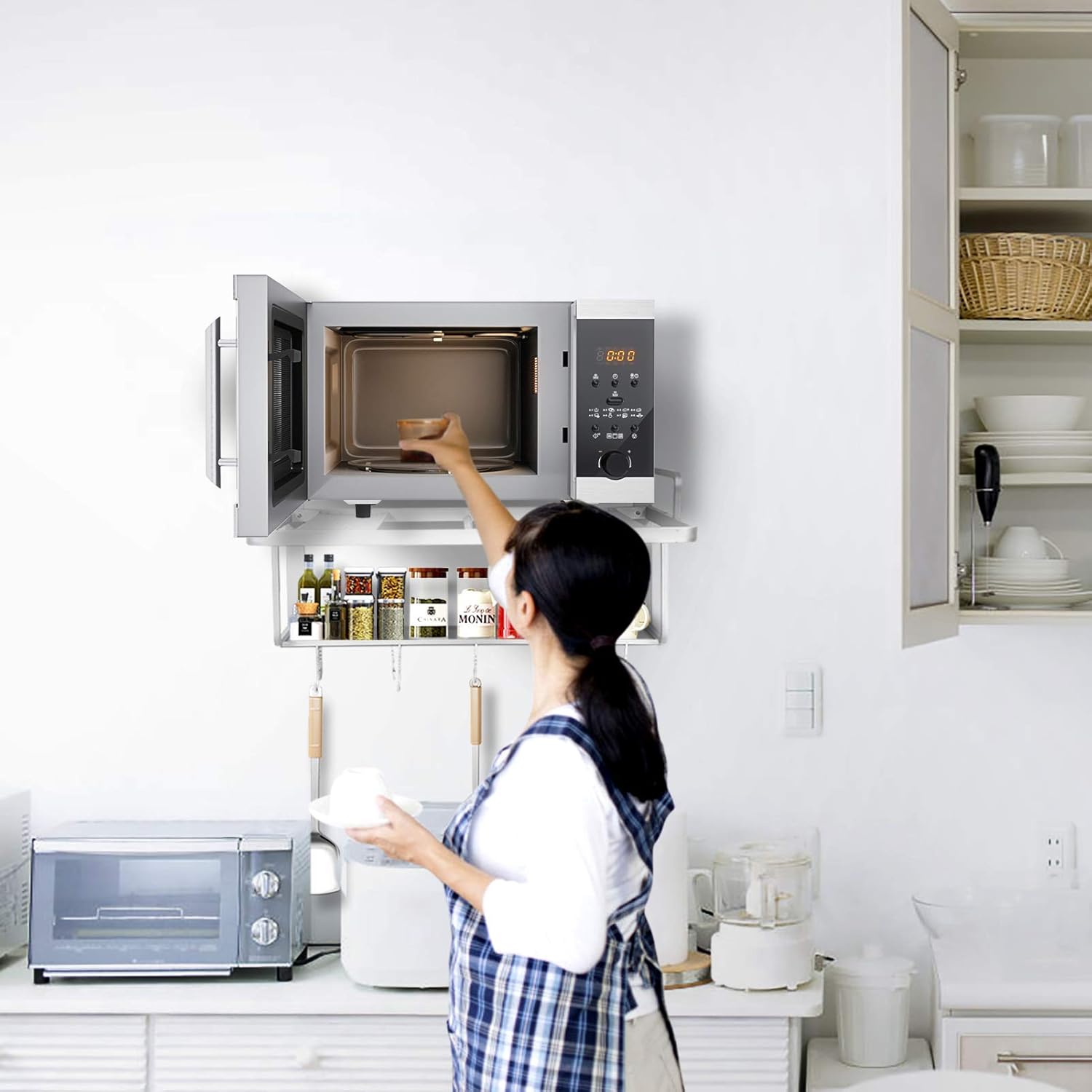 Person using a microwave in a kitchen