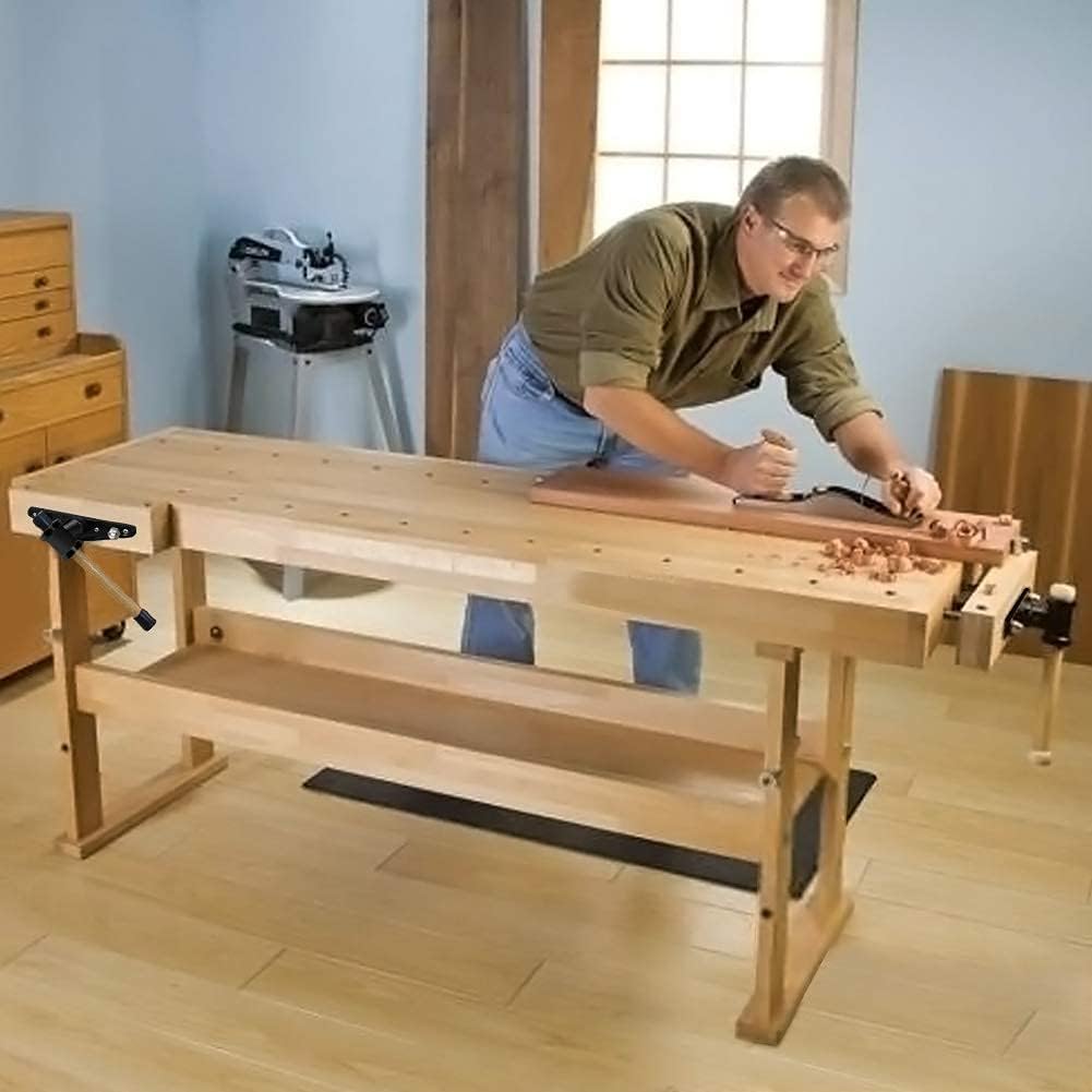 Man working on a wooden workbench in a workshop setting