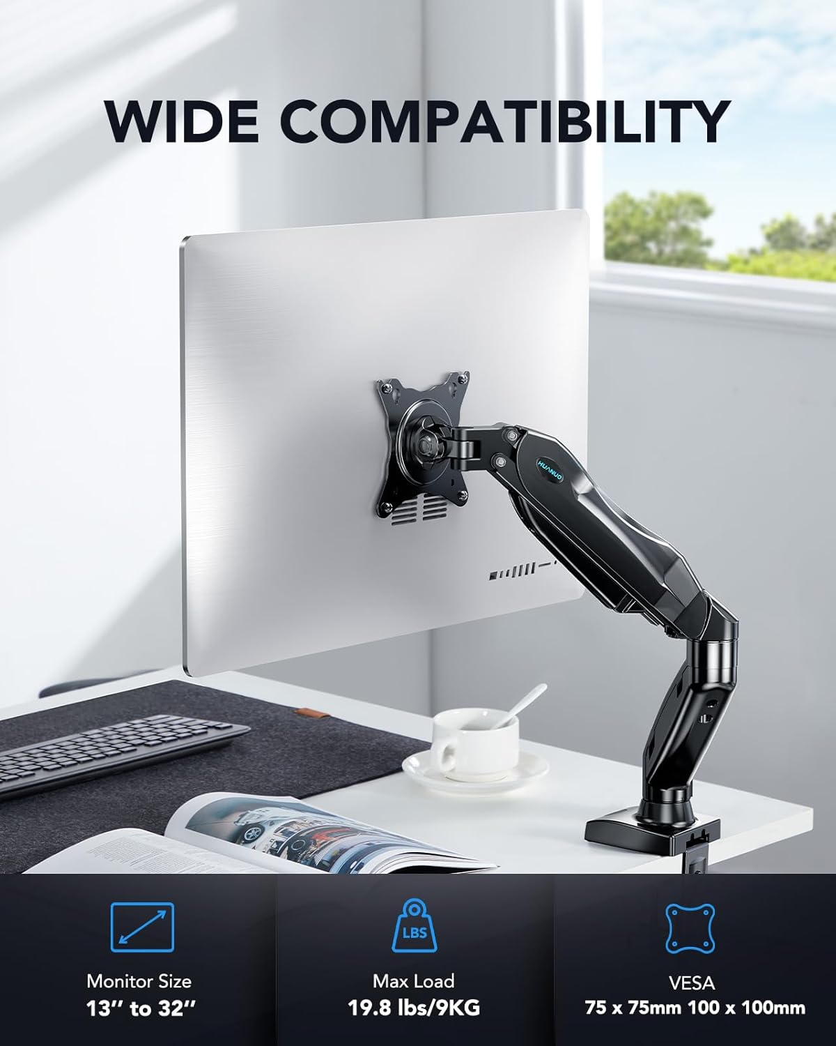 Monitor stand with wide compatibility text and product details on a desk.