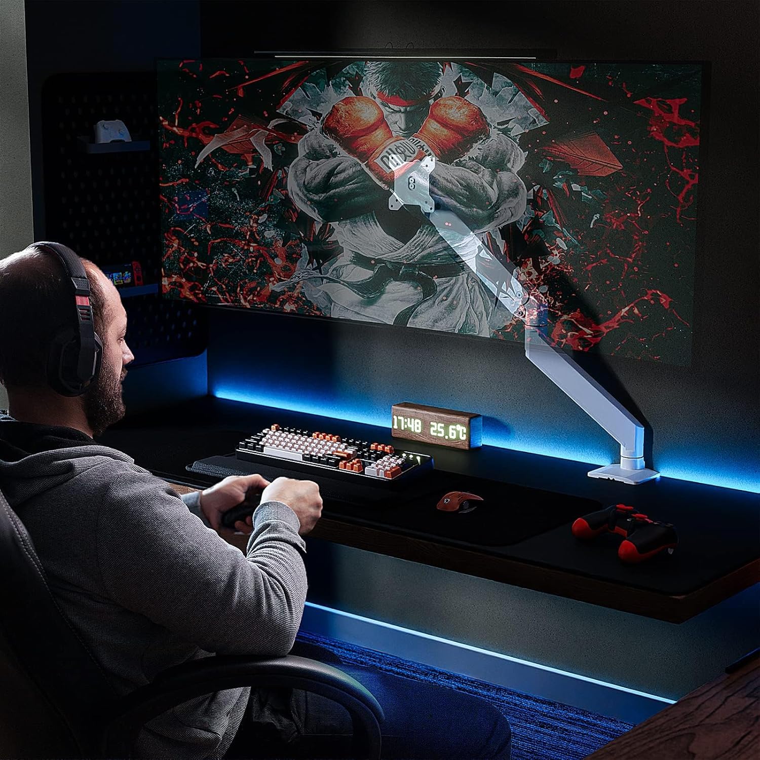 Person playing a video game on a computer setup with a monitor displaying a colorful game.