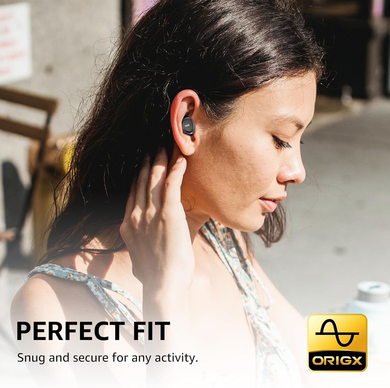 Woman wearing wireless earbuds with 'Origx' branding and text about perfect fit.