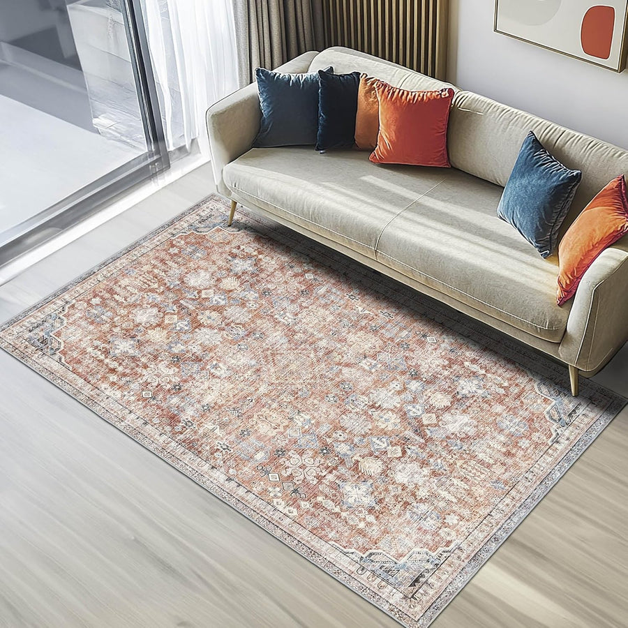 Beige sofa with colorful pillows on a patterned rug in a modern living room.