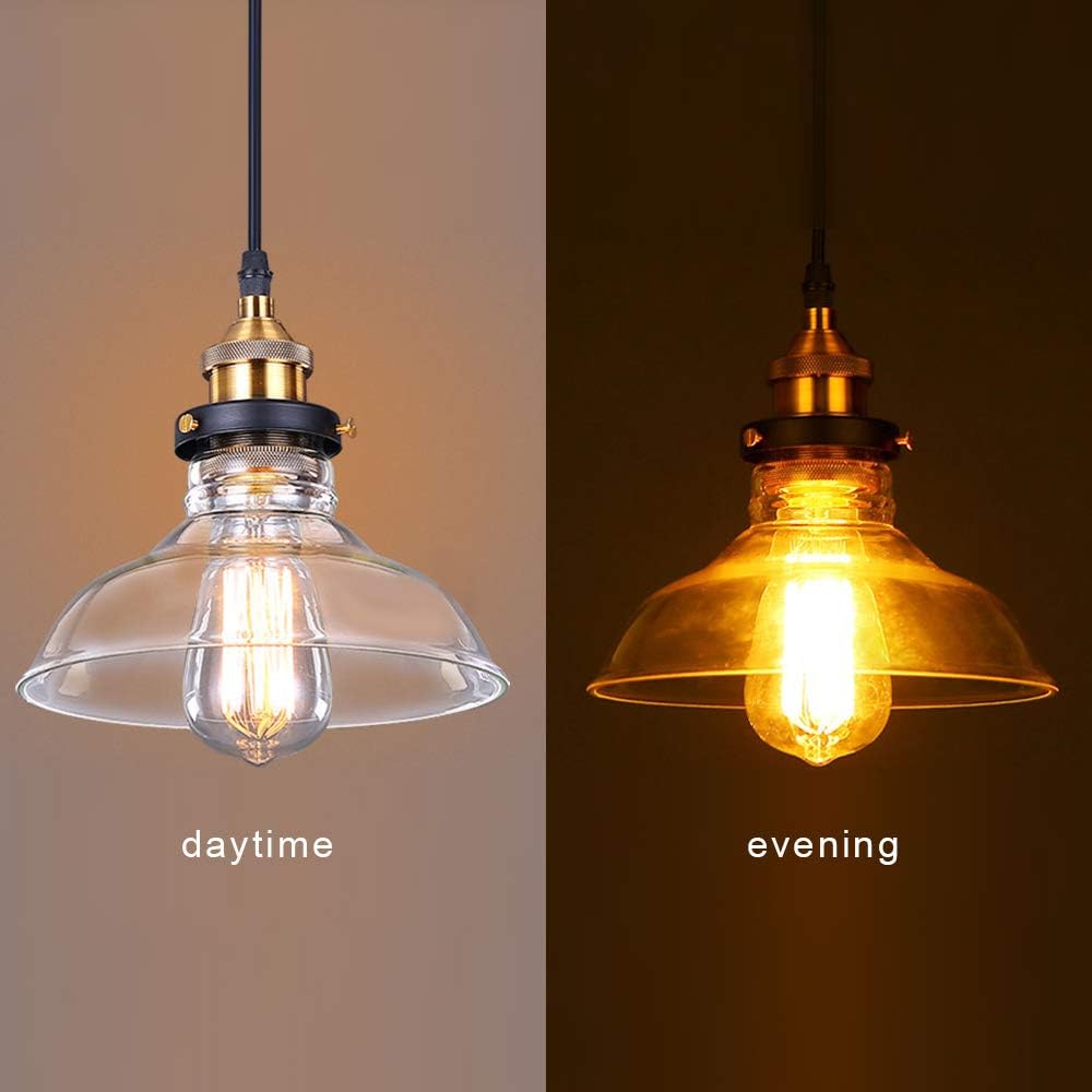 Two pendant lights showing a clear glass shade during daytime and a yellowed glass shade during evening.