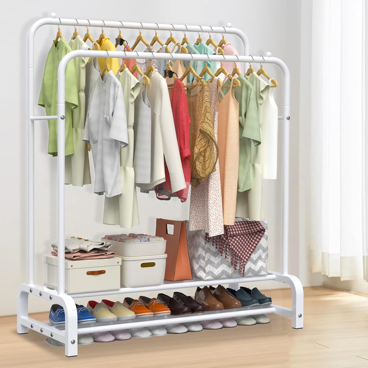 Clothing rack with clothes and shoes on a wooden floor.