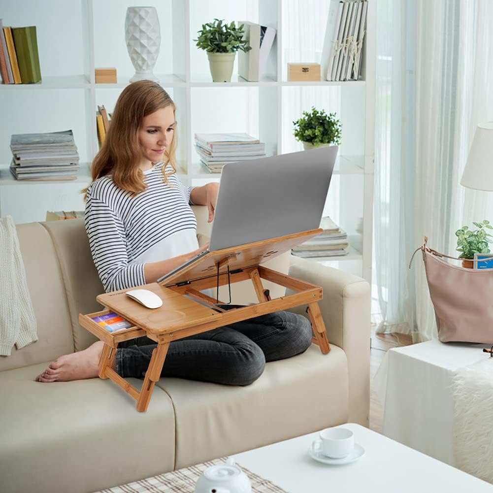 Woman using a laptop on a wooden lap desk in a home setting